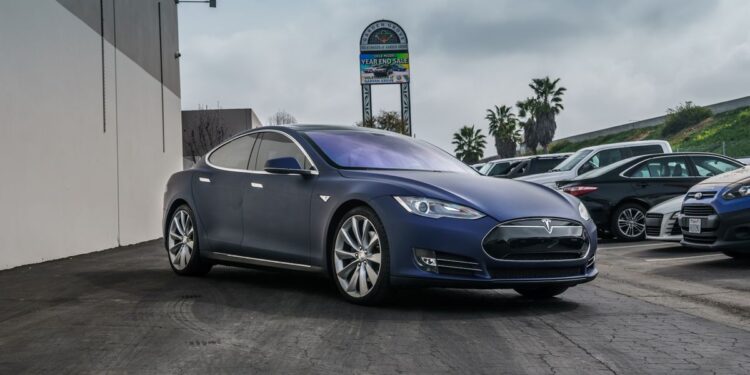 Tesla dealership storefront in California showing electric vehicles on display
