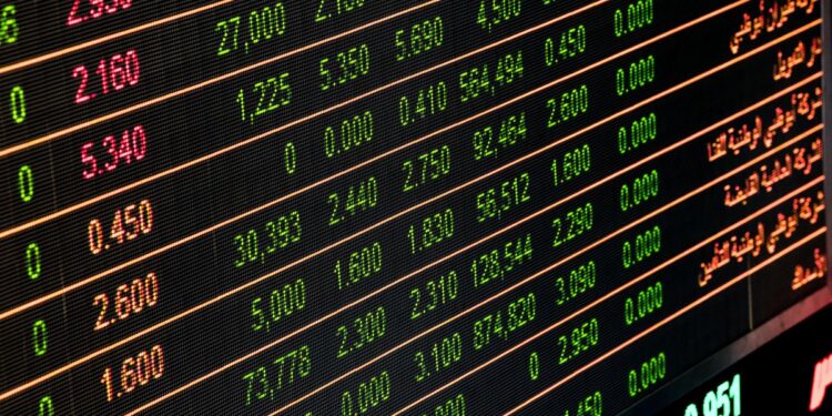 Trading floor of a stock exchange with electronic displays showing market data